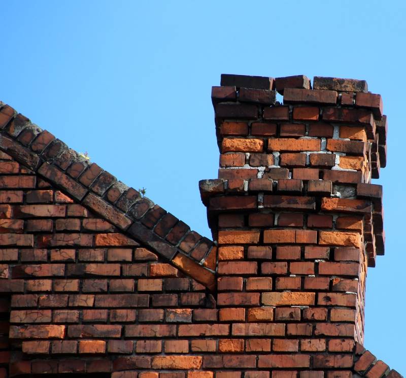 Signs Your Berwyn Home Needs a Chimney Inspection Damaged chimney on an Berwyn home showing cracks and missing mortar